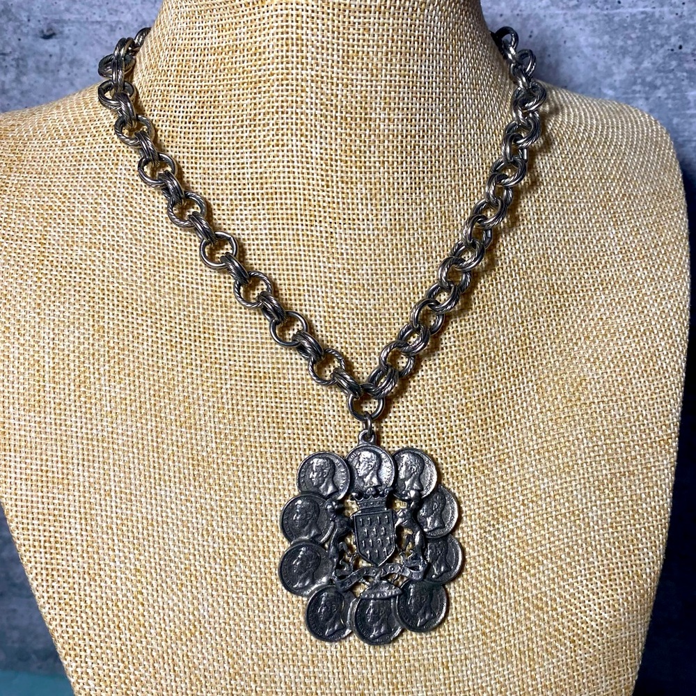 Vintage Reinad silver tone cluster of coins circling around crest with stags